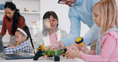 Image of Technology, girls or robotics in classroom with teacher for learning, education or electronics with car toys for innovation. School kids, learners or transport knowledge in science class for research