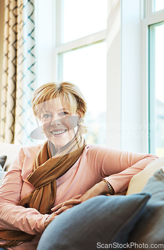 Image of Portrait, smile or mature woman in living room to relax with freedom on couch or sofa at home. Apartment, calm or happy senior person with peace or wellness in retirement, lounge or house for resting