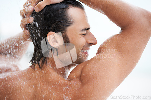 Image of Shower, happy and man with water for cleaning, washing hair and grooming for healthy skin. Beauty, spa treatment and person smile with splash for hygiene, wellness and skincare hydration and cleanse