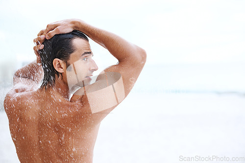 Image of Shower, beach and man with water for washing, cleaning hair and grooming for healthy skin. Back mockup, treatment and person with splash for natural hygiene, wellness and skincare hydration