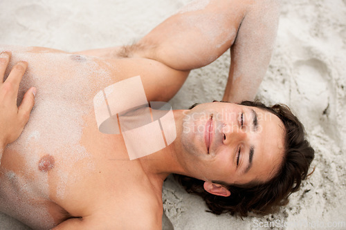 Image of Man, smile and lie beach sand relax or summer vacation calm, tropical destination or holiday fresh air. Male person, happy and shirtless at ocean alone for outdoor peace, sunshine lazy or travel fun