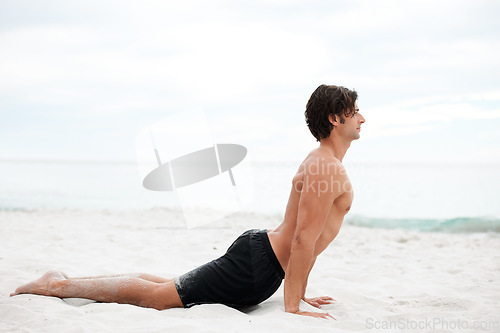 Image of Man, yoga and stretch on beach sand for relax summer, zen or sunshine exercise for health. Male person, cobra pose and muscle for holistic sea practice, spiritual balance or calm ocean mockup