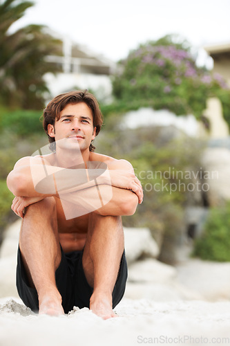 Image of Man, thinking and sitting on beach sand relax vacation, sunshine holiday or tropical ocean trip. Male person, calm face and sea fresh air or summer outdoor swimwear, travel scenery or barefoot shore