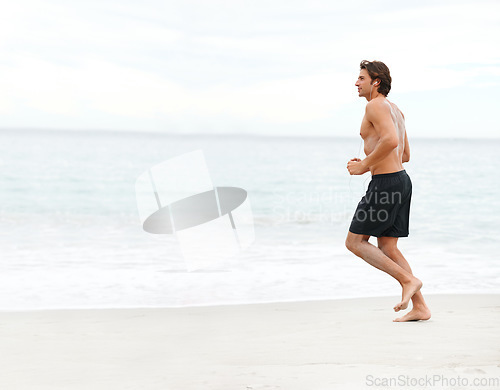 Image of Man, music and running on beach cardio workout, exercise playlist or summer sport training. Male person, streaming listening and fitness at sea or headphones speed performance, healthy body or audio