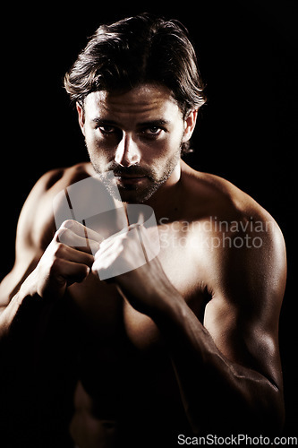 Image of Portrait, body of man and boxer fight in studio isolated on a black background. Face, boxing and muscle of topless athlete with fist ready for exercise, training or workout, sport and combat fitness