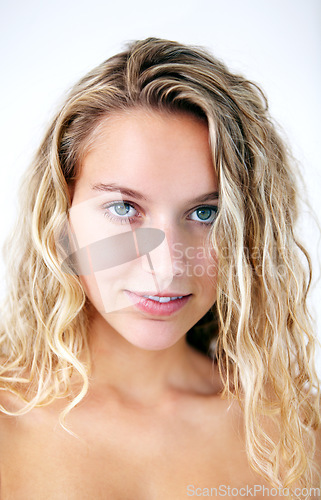 Image of Portrait, happy woman and hair care, curls or natural beauty cosmetic in studio. Face, blonde model and smile for hairstyle in salon, healthy facial skincare or wellness isolated on white background