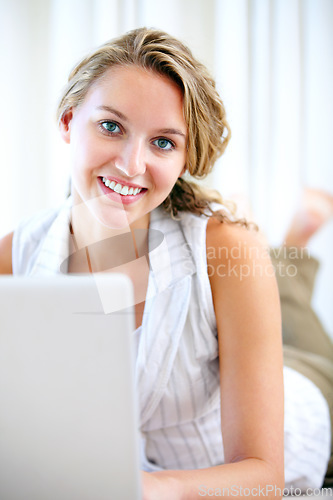 Image of Portrait, laptop and smile of woman in home on floor for networking, typing email and relax. Computer, happy face and girl on internet, search and communication on social media, website and online