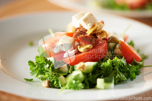 Image of Background, salad and healthy plate of food for lunch, dinner and nutrition for detox, diet or eating in cafe. Closeup, vegan cuisine or dining in restaurant for meal of leafy greens, tomato and feta