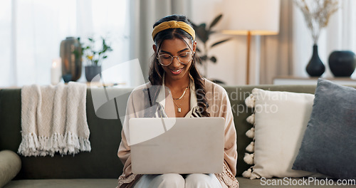 Image of Laptop, remote work and happy woman on a sofa for social media, research or reading a home. Tech, freelance and female entrepreneur online in a living room with email, chat or upskill course search