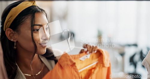 Image of Sale, shopping and happy woman at a mall for clothes, outfit or thrift store fashion choice. Retail, decision or Indian customer check boutique fabric quality, clothing rack or discount deal search