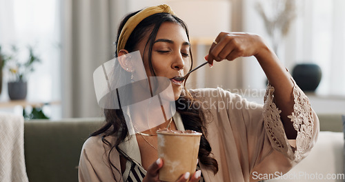 Image of Woman, eating ice cream and living room on sofa, thinking or idea for dessert, sweets or relax in home. Girl, gelato or frozen yogurt for snack, lounge couch and house with memory, choice or decision