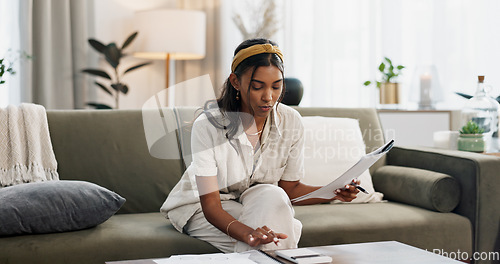 Image of Woman, calculator and budget on sofa of home finance, taxes documents and income or salary management. Young person with paperwork, invoice or loan, inflation and bills for rent cost in living room