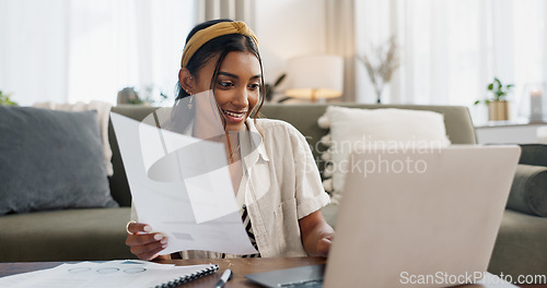 Image of Woman, work from home and documents on laptop for online research, financial planning and data report. Young worker or freelancer typing on her computer with paperwork, bills and taxes in living room