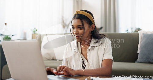 Image of Home, woman typing on laptop and remote work, internet search or blog in living room. Computer, smile and Indian freelancer in lounge on table, online website or reading email on digital technology
