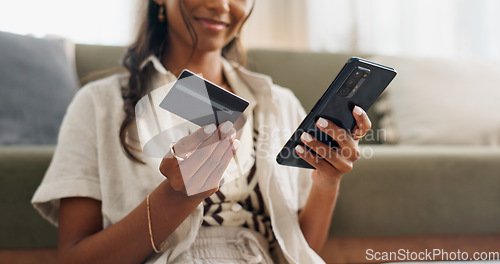 Image of Happy woman, hands and phone with credit card for online shopping, payment or transaction in living room at home. Closeup of female person or shopper on mobile smartphone with debit for ecommerce