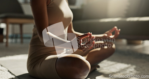 Image of Woman, yoga and meditation hands on floor, house and peace for chakra balance, relax and healthy in living room. Girl, body and spiritual for pilates, closeup and wellness with zen mindfulness