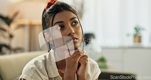 Image of Thinking, reflection and young woman on a sofa relaxing with an idea or memory in living room. Anxious, mental health and nervous Indian female person with decision in the lounge of modern apartment.