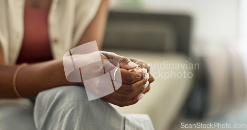 Image of Anxiety, hands and closeup of woman on a sofa with fear, worry or mental health crisis at home. Stress, zoom and female person in living room with conflict trauma, ptsd or disaster, mistake or abuse