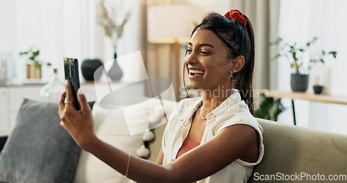 Image of Woman, selfie and smile on sofa in home living room with web blog, post or update on mobile app. Influencer girl, live streaming or video call with memory, profile picture and social media in house