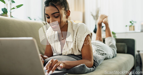 Image of Woman, remote work and relax on sofa with laptop to update blog post, social media or digital subscription. Happy indian freelancer, lounge and computer for online shopping, elearning or typing email