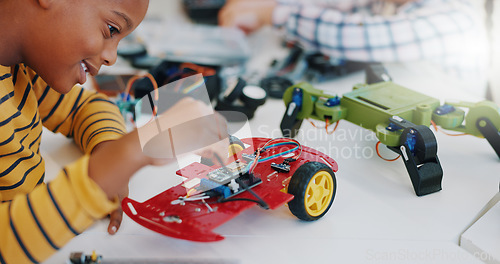 Image of Robotics, boy and technology in classroom for education or learning electronics with car toys for innovation. School kids, learners and transportation knowledge in science class for research or study