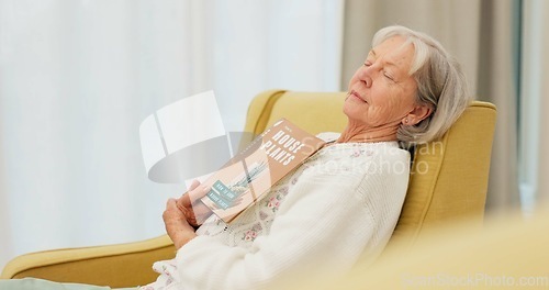 Image of Relax, book and senior woman sleeping in the living room of her modern house on a weekend. Calm, peace and elderly female person in retirement taking a nap after reading a story or novel at home.
