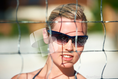 Image of Volleyball, fitness and face of woman at a beach for summer, fun or sports workout outdoor. Exercise, net and female athlete at the sea for handball training, performance or holiday travel in Miami
