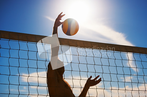 Image of Volleyball, fitness and man at beach with ball serve, energy or freedom on blue sky background. Seaside, sports or male player with handball in nature for cardio, workout or athletic game performance