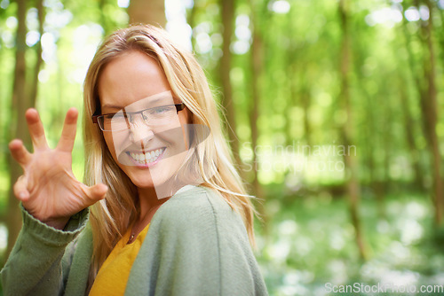 Image of Woman, glasses or nature with hand for playful, growl by countryside with portrait in trendy fashion. Sweden, person or happy face for eyewear in natural glow, outdoor fun or sunshine to joke in park