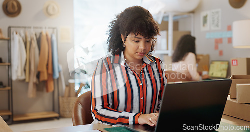 Image of Small business, typing and woman with laptop in office for logistics, sales or ecommerce order. Fashion, supply chain and lady store owner online for communication, cargo or retail stock procurement