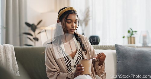 Image of Woman, eating ice cream and home on sofa, thinking or idea for dessert, sweets or relax in living room. Girl, gelato or frozen yogurt for snack, lounge couch and house with memory, choice or decision