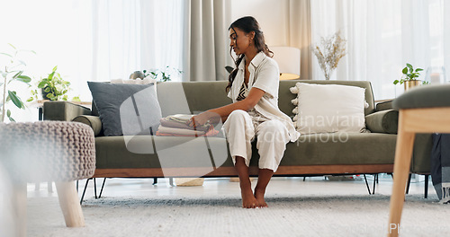Image of Woman, laundry and living room sofa for household spring cleaning, apartment cleaner or fresh home. Indian person, proud or clothes lounge for happy linen, sanitary hygiene or tidy washing fabric