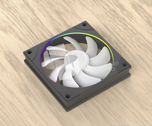 Image of Computer fan on wooden desk
