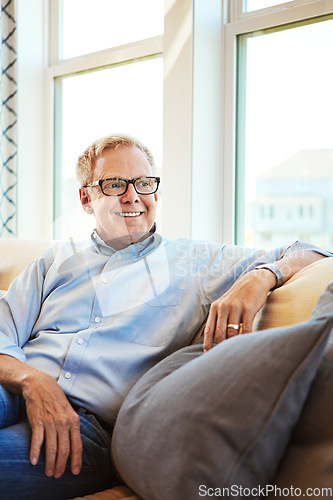 Image of Thinking, mature or happy man in living room to relax with ideas on sofa or couch at home for resting. Calm, glasses or senior male person with smile, peace or wellness in retirement, lounge or house