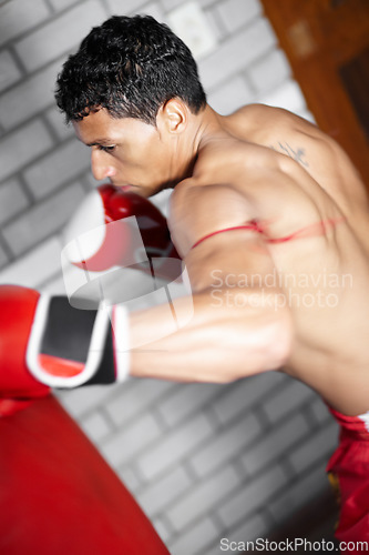 Image of Power, punching bag or sports man, boxer or fighter training performance for kickboxing contest, competition or challenge. MMA action, gym equipment or strong warrior practice impact for boxing fight