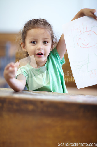 Image of Portrait, drawing and student in a classroom, girl and creative with happiness, learning and smile. Face, child or kid with paper, showing her art or excited with joy, school and study with education