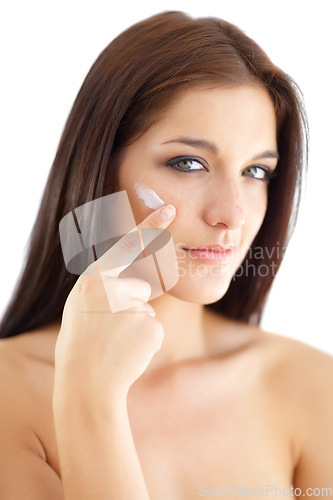 Image of Portrait, woman and apply of moisturiser in studio in skincare cosmetic on white background. Model, person and lotion for anti-aging results, hydration or vitamin c in pigmentation or collagen boost