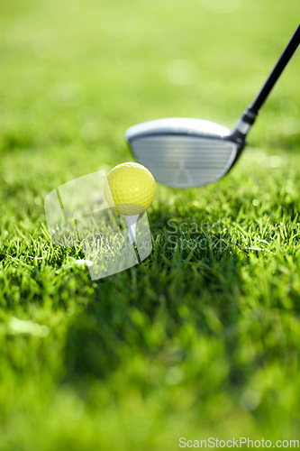 Image of Closeup, golf ball and tee for swing on driving range for sports competition, recreation hobby or practice. Target, challenge and tournament on field in summer for training with equipment on grass