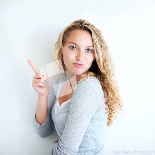 Image of Woman, portrait or pointing for announcement hand, information on white background. Female person, face and finger gesture emoji for presentation introduce or mockup space, fun or show opportunity