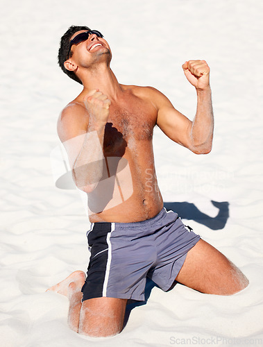 Image of Beach, celebration and fitness man with winner fist in sand for exercise, success or growth milestone. Freedom, energy and excited athlete in nature with sports achievement, victory or training win