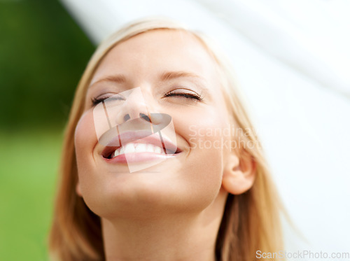 Image of Happy, freedom and face of woman with fabric closeup in garden with clean linen, laundry or sheet in the wind. Natural, beauty and girl with a white cloth and happiness in house backyard or nature