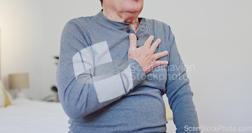 Image of Hands, chest pain and closeup of elderly man in bedroom with injury, hurt or accident at nursing home. Sick, ill and zoom of senior male person in retirement with asthma or heart attack at house.