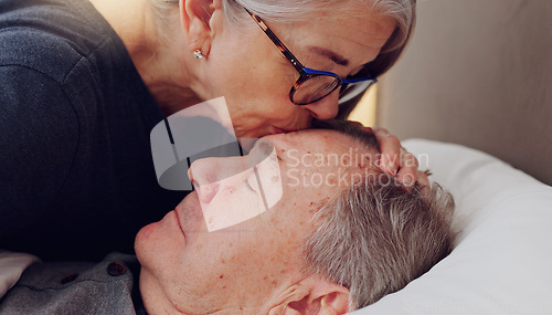 Image of Senior woman kissing her husband on forehead with love, care and marriage in bed at home. Sick, recovery and elderly couple in retirement with illness in bedroom of hospice, nursing center or house.