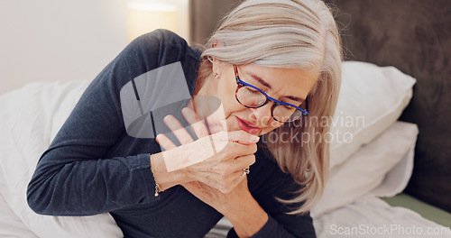Image of Sick, cough and senior woman in bed with allergies, flu or cold on a weekend morning at home. Illness, chest pain and elderly female person in retirement with asthma or infection in bedroom at house.