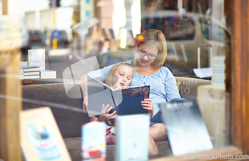 Image of Reading, books and mother with child in bookshop window with smile, learning and relax with knowledge. Storytelling, happy mom and girl in library together with story, fantasy and education in window