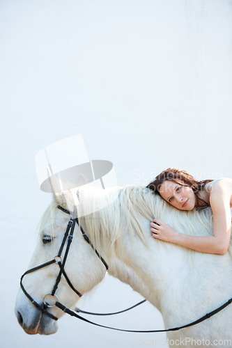 Image of Wall, portrait and woman laying on her horse outdoor for sports racing or riding hobby. Smile, happy and young person from Canada with her equestrian animal or pet by a ranch for adventure and love.