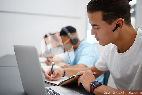 Image of Studying, notebook and laptop with students in university classroom, library or workspace for learning, education and exam. Young college people writing lecture notes, research and digital technology