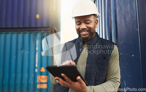 Image of African american shipyard worker, shipping logistics and transportation of international commercial goods. Tablet for inventory management, import and export of cargo in the distribution supply chain