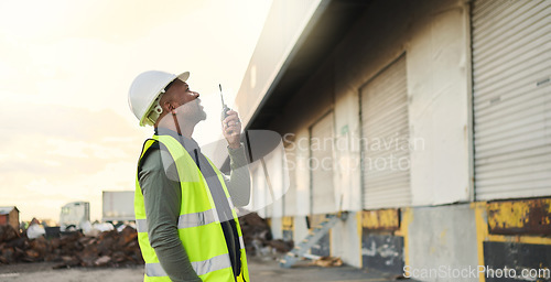 Image of Construction worker, engineer black man manager on site inspection for building, warehouse or industrial project development. Outdoor contractor businessman and walkie talkie communication management