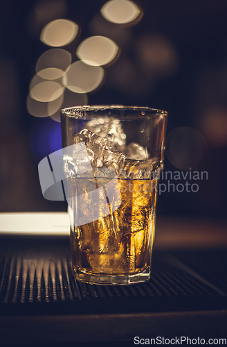 Image of Glass of whiskey on the ice rocks